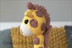 a crocheted stuffed giraffe is shown