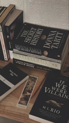 several books sitting on top of a wooden table