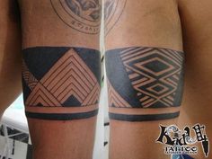 two men with matching tattoos on their arms