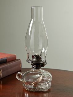 This beautifully crafted glass chamber lamp is the perfect accent to a side table or nightstand, bringing a timeless look and warm glow anywhere in your home. Thanks to the finger loop on the side of the lamp, you can also easily take this hurricane lamp from room to room. Use this oil lamp for ambient lighting every day and keep it close for those times when the power goes out. And with no batteries to replace or bulbs to burn out, you'll appreciate the peace of mind it brings! Oil lamp comes wicked and ready for oil Provides brighter illumination than the open flame of a candle 360 degrees of hands-free light Crafted in clear glass with a metal burner with a metal turning knob to control the flame Sturdy base with finger loop for easy carrying Includes a 1/2-inch wide wick Burns 20 hours Lamp Display, Vermont Country Store, Magical Thinking, Light Crafts, Room To Room, Country Store, Burn Out, Oil Lamp, Beautiful Lamp