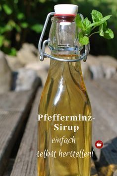 a glass bottle filled with liquid sitting on top of a wooden table