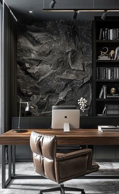 a desk with a laptop on it in front of a bookcase