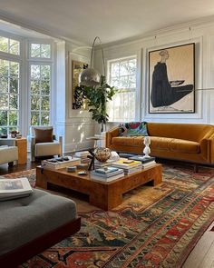 a living room filled with furniture and lots of windows