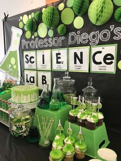 a science themed party with green and white decorations