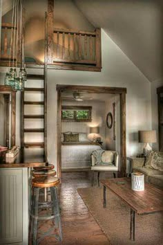 a living room filled with furniture and a loft