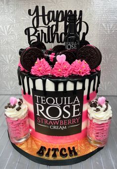 a birthday cake decorated with pink and black frosting