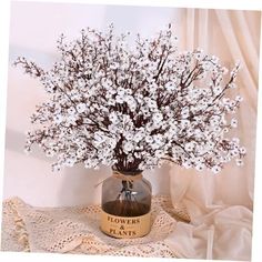 a vase filled with white flowers on top of a table