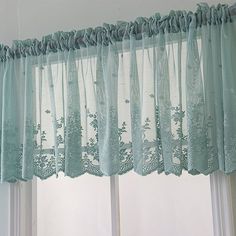 the curtains are hanging in front of the window