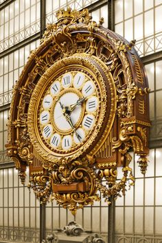 an ornate clock in front of a large window