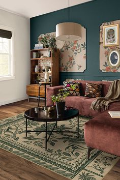 a living room filled with furniture and decor on top of a hard wood floored floor