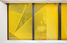 an abstract yellow and black design on the side of a building