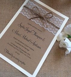 a brown and white wedding card on top of a table