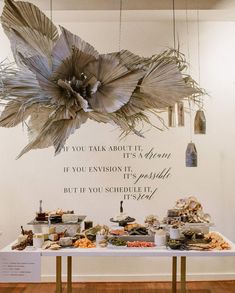 a table topped with lots of food next to a wall