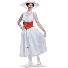 a woman in a white dress and hat with red trimmings is posing for the camera