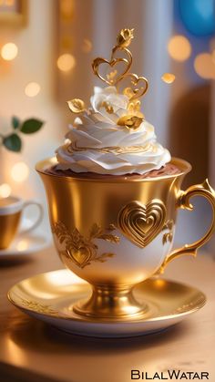 a golden cup filled with white frosting on top of a saucer