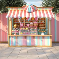 an ice cream stand with colorful striped awnings and cupcakes on display