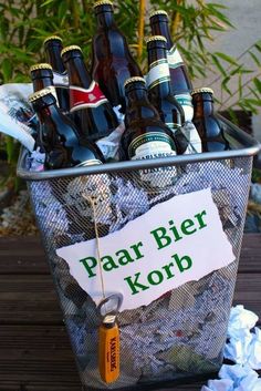 a basket full of beer bottles sitting on top of a wooden table next to trash