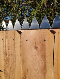 a wooden fence that has some plants growing on it