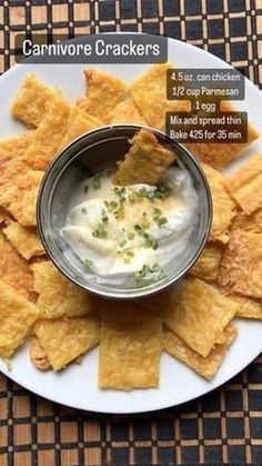 a white plate topped with crackers and dip