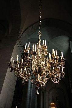 a chandelier hanging from the ceiling in a church