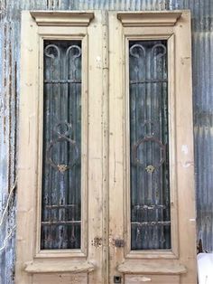 an old pair of double doors in front of a building