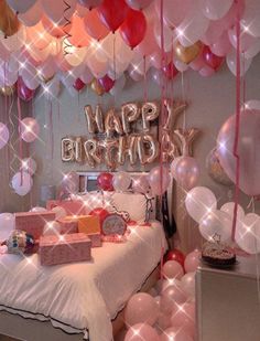 a bedroom decorated with balloons and gifts for a birthday