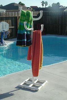 two towels are hanging next to a swimming pool