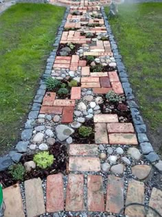 a long brick path made out of small stones