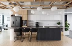 an open kitchen and dining area with bar stools