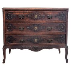 an old wooden dresser with ornate carvings on the top and bottom drawers, against a white background