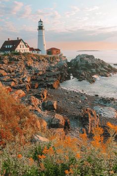 a light house sitting on top of a cliff next to the ocean