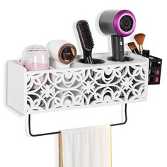 a white shelf with hairdryers, brushes and other items on top of it