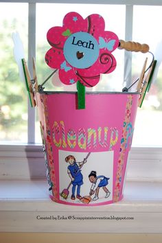 a pink flower pot sitting on top of a window sill next to a pair of scissors