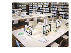 there are many computers that are on the desks in this library with bookshelves