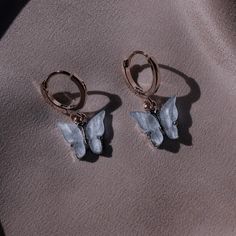 pair of earrings with two small grey birds on them