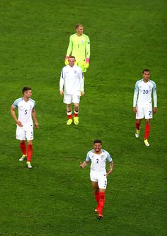 the soccer players are walking on the field