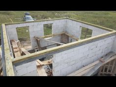 an unfinished house being built in the middle of a field