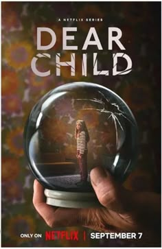 a hand holding a glass ball with the words dear child on it and an image of a