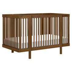 a wooden crib with white sheets on the bottom and side rails, against a white background