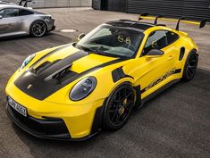 two yellow sports cars parked next to each other