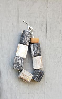 a wreath made out of old blocks hanging on the side of a building or door