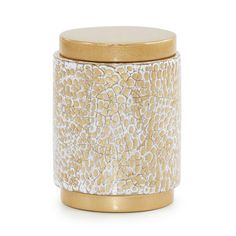 a gold and white canister with a metal lid on the bottom, in front of a