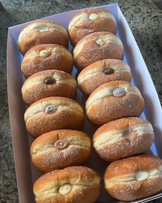 a box filled with lots of donuts covered in frosting