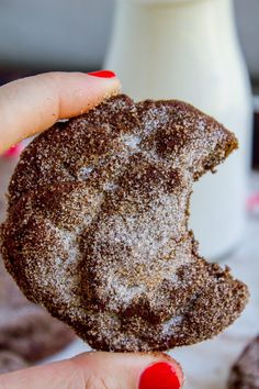 a person holding a cookie in their hand