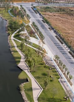 an aerial view of a river and road