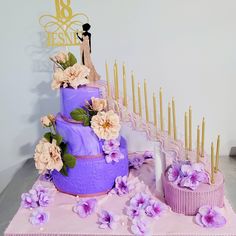 there is a purple cake with flowers on it