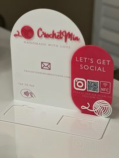 a red and white business card sitting on top of a table