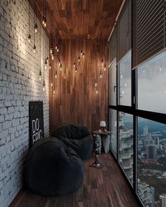 a large bean bag chair sitting on top of a wooden floor next to a window