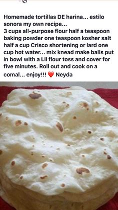 a tortilla cake sitting on top of a red cloth covered in white frosting