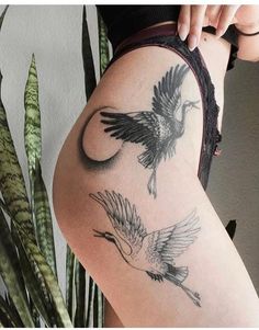 a woman's thigh with two birds on it